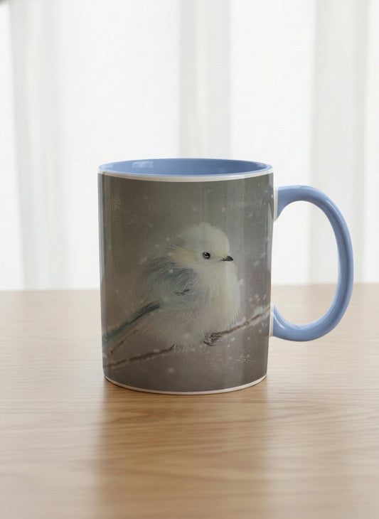 classic mug | A Moment in the Snow mug, a fluffy white bird perched quietly in a soft wintry haze, sky blue interior and handle, by Karina Mosser - Gallery By Inhesion