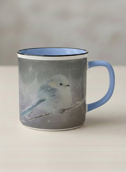 Enamel mug | A Moment in the Snow mug, a fluffy white bird perched quietly in a soft wintry haze, sky blue interior and handle, by Karina Mosser - Gallery By Inhesion