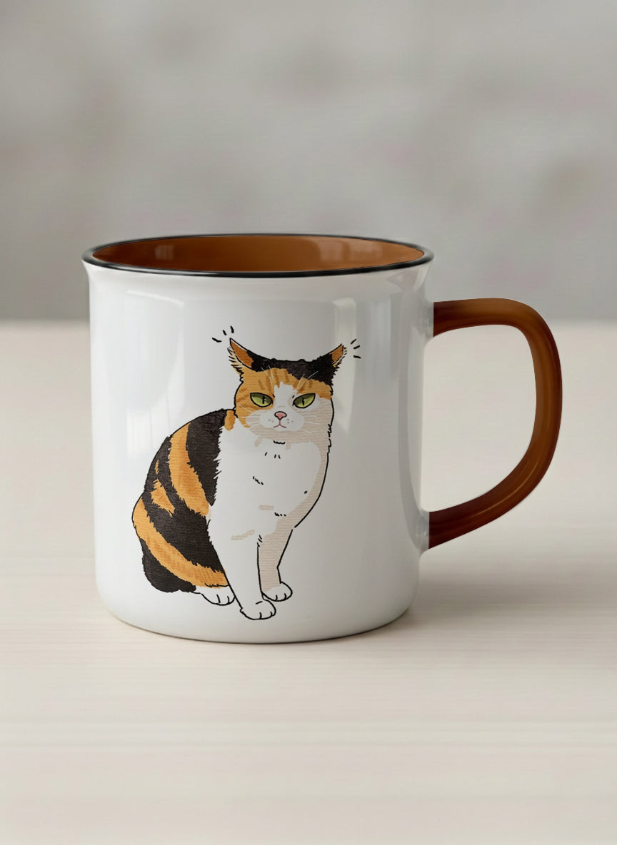 enamel Mug | Spicy Calico mug grumpy calico cat with piercing green eyes and ruffled fur, dark chocolate interior, by Hyun Jung Cho