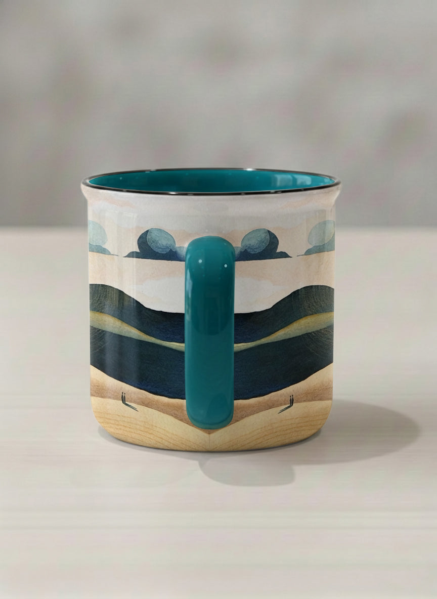 enamel mug | Share a Sunset side view  mug a lone figure walking through rolling sand dunes beneath a glowing orange sun and layered teal clouds, deep teal interior and handle, by KikaG - Gallery By Inhesion