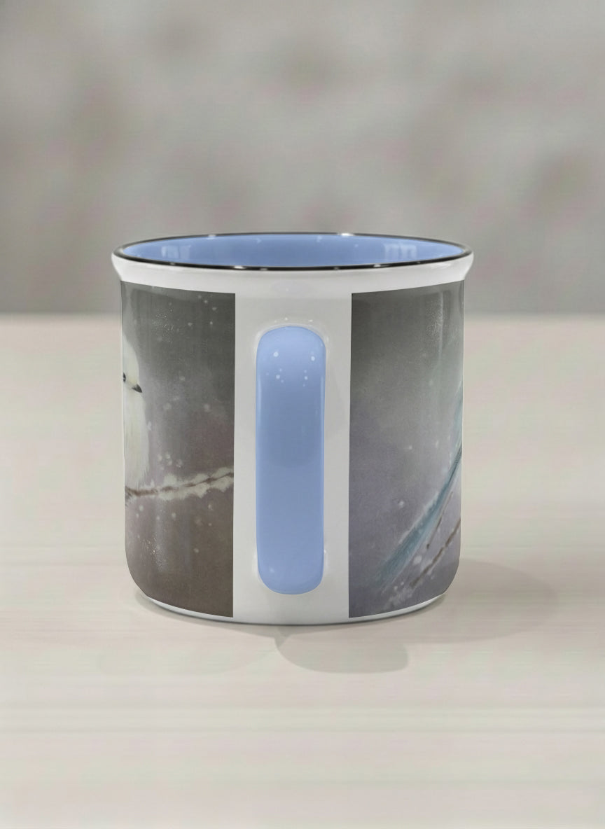enamel mug | A Moment in the Snow side view mug, a fluffy white bird perched quietly in a soft wintry haze, sky blue interior and handle, by Karina Mosser - Gallery By Inhesion