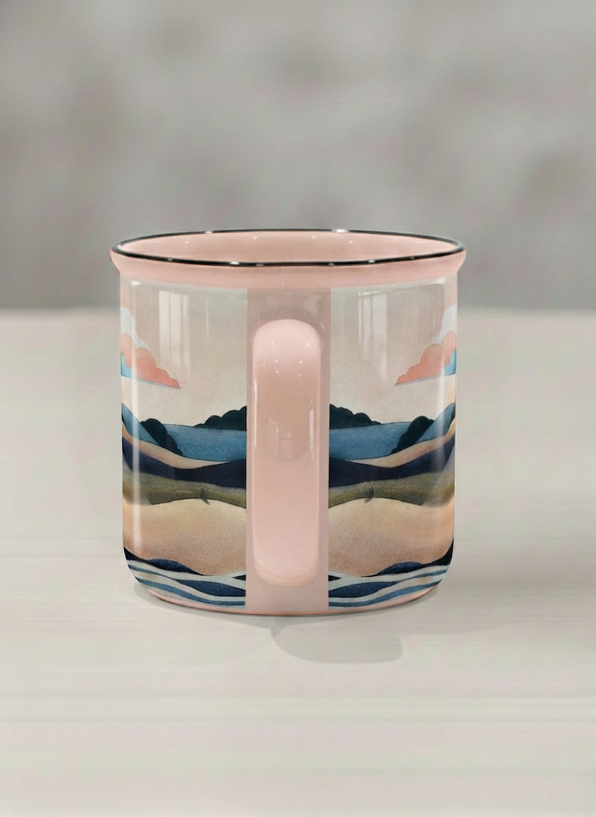 Enamel mug | Sunset at the River side view mug rolling hills and dark treetops beneath a soft peach sky with blush and teal clouds and a glowing setting sun, warm peach interior and handle, by KikaG - Gallery By Inhesion