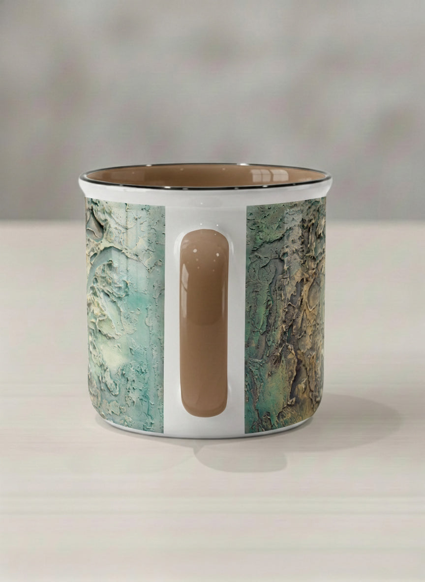 Enamel Mug | Green textured side view mug with earthy, weathered pattern and brown handle on a light surface by Mersedes Mein - Gallery By Inhesion