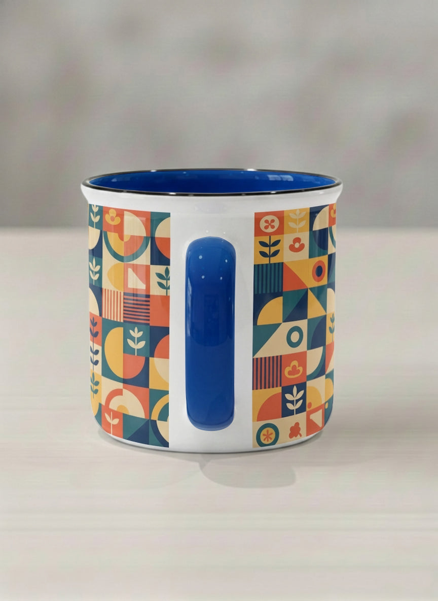 Enamel Mug | Bloom Across Realities side view mug, bold geometric pattern, blue interior and handle, concrete surface  by Alan CL Lee - Gallery By Inhesion