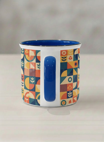 Enamel Mug | Bloom Across Realities side view mug, bold geometric pattern, blue interior and handle, concrete surface  by Alan CL Lee - Gallery By Inhesion