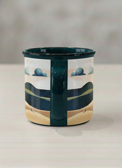 Enamel mug | Share a Sunset side view mug a lone figure walking through rolling sand dunes beneath a glowing orange sun and layered teal clouds, deep teal interior and handle, by KikaG - Gallery By Inhesion
