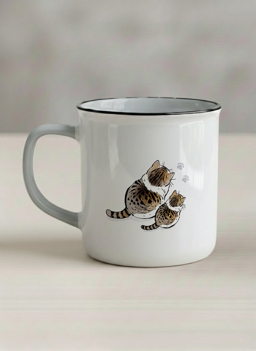 enamel mug | By Your left view mug with two cats and paw prints, by Hyun Jung Cho- Gallery By Inhesion