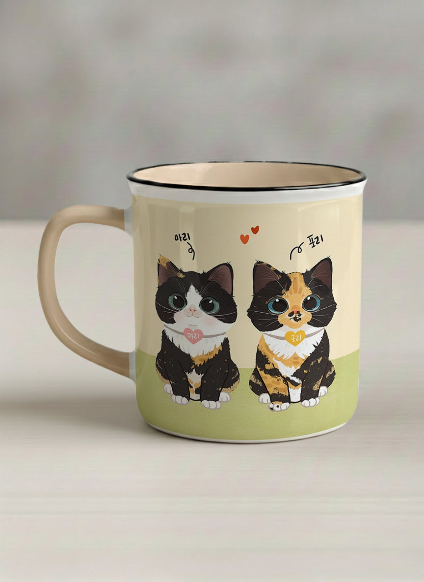 Enamel mug | Our Precious Pair left view mug, two adorable tuxedo cats side by side with Korean name tags and tiny red hearts, soft cream interior and handle, by Hyun Jung Cho - Gallery By Inhesion