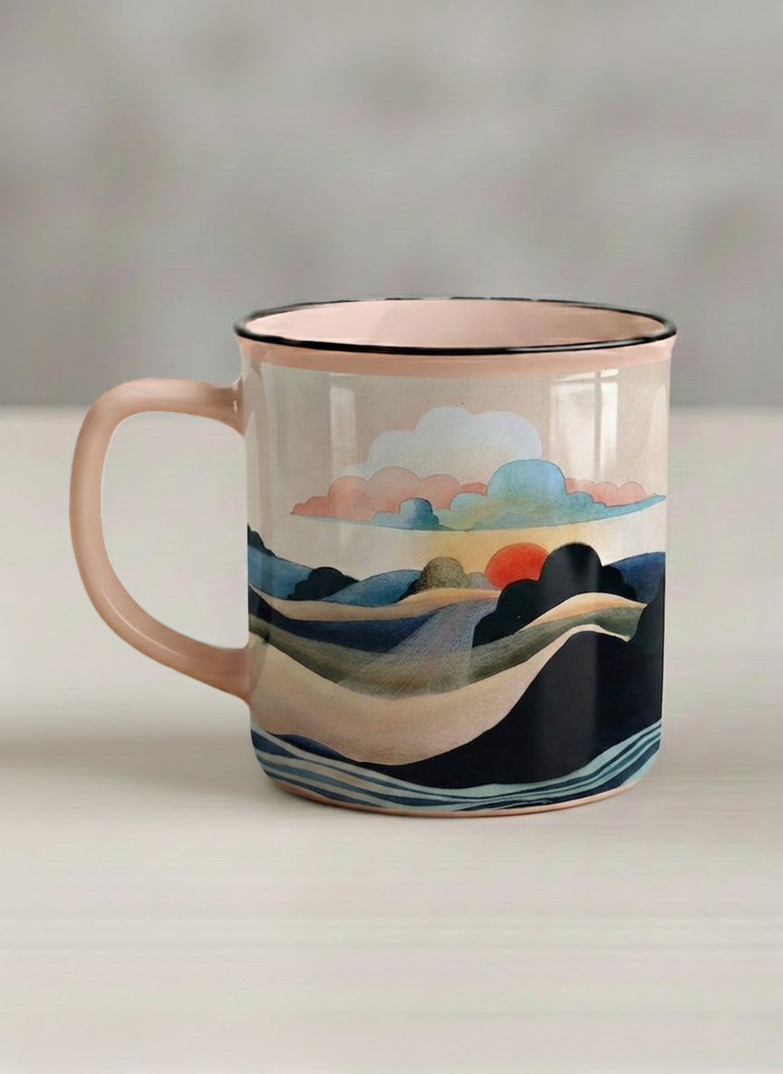 Enamel mug | Sunset at the River left view mug rolling hills and dark treetops beneath a soft peach sky with blush and teal clouds and a glowing setting sun, warm peach interior and handle, by KikaG - Gallery By Inhesion