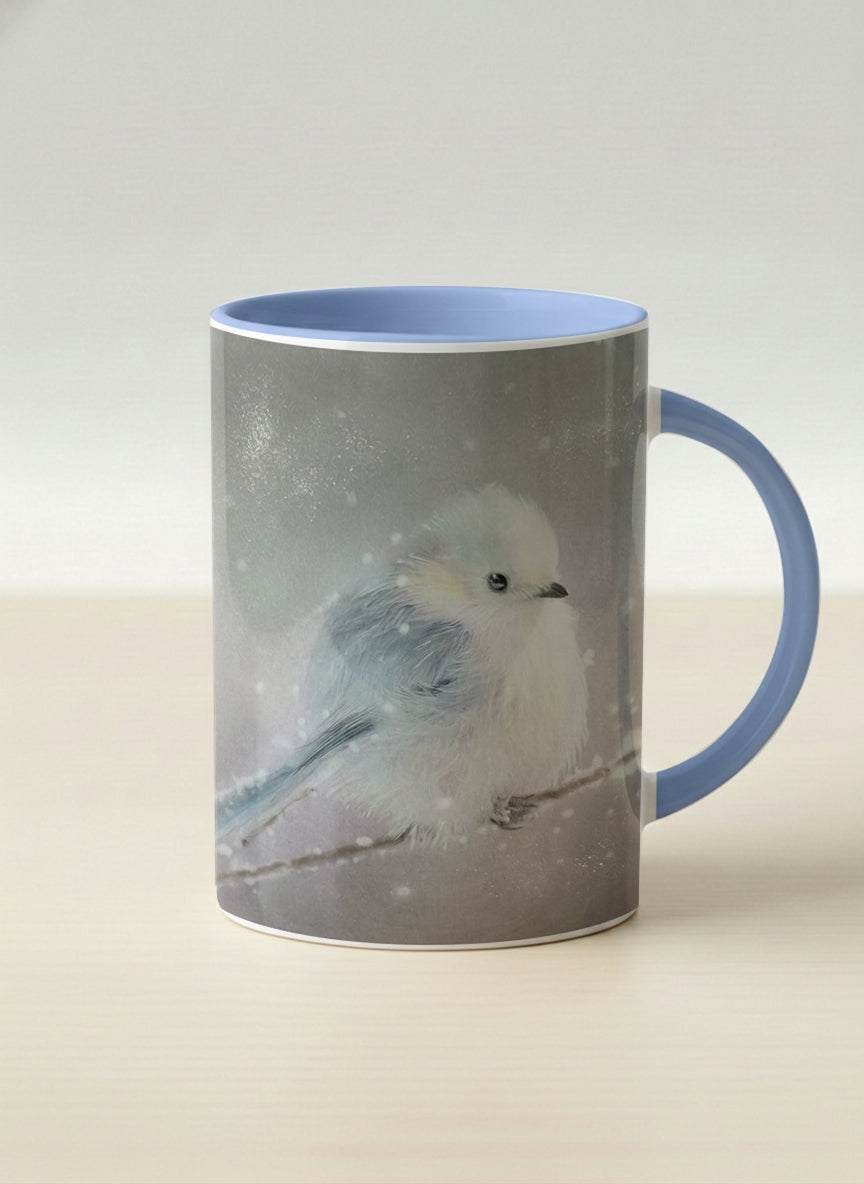 Hero mug | A Moment in the Snow mug, a fluffy white bird perched quietly in a soft wintry haze, sky blue interior and handle, by Karina Mosser - Gallery By Inhesion
