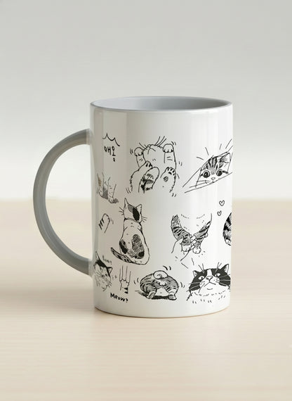 hero mug | Moments of Curiosity left view mug  ink-sketched cats in playful poses with Korean script on white, grey interior, by Hyun Jung Cho