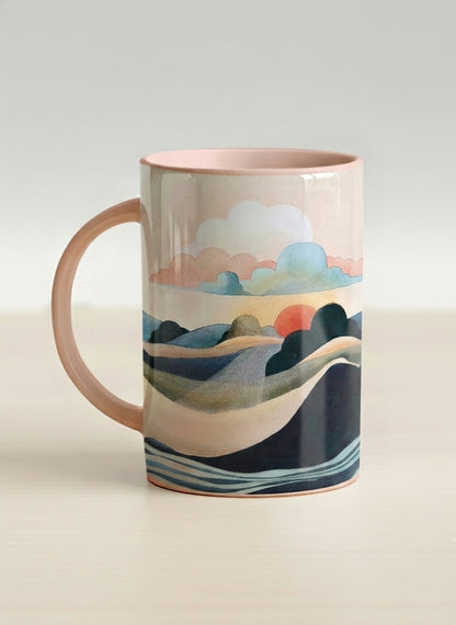 hero mug | Sunset at the River left view mug rolling hills and dark treetops beneath a soft peach sky with blush and teal clouds and a glowing setting sun, warm peach interior and handle, by KikaG - Gallery By Inhesion