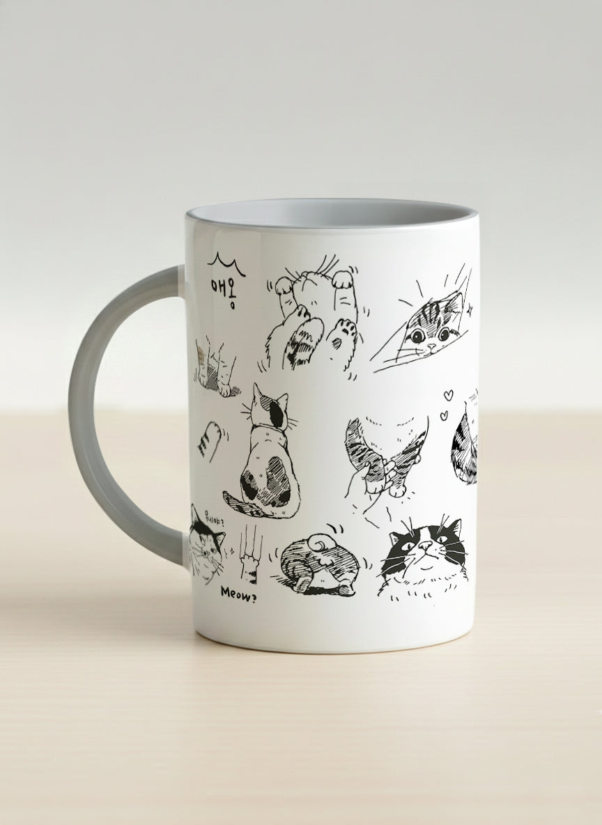 Hero mug | Moments of Curiosity left view mug  ink-sketched cats in playful poses with Korean script on white, grey interior, by Hyun Jung Cho