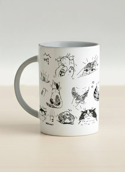 Hero mug | Moments of Curiosity left view mug  ink-sketched cats in playful poses with Korean script on white, grey interior, by Hyun Jung Cho