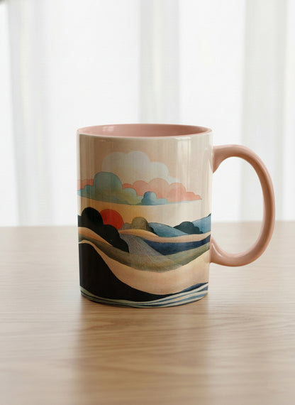 classic mug | Sunset at the River mug rolling hills and dark treetops beneath a soft peach sky with blush and teal clouds and a glowing setting sun, warm peach interior and handle, by KikaG - Gallery By Inhesion