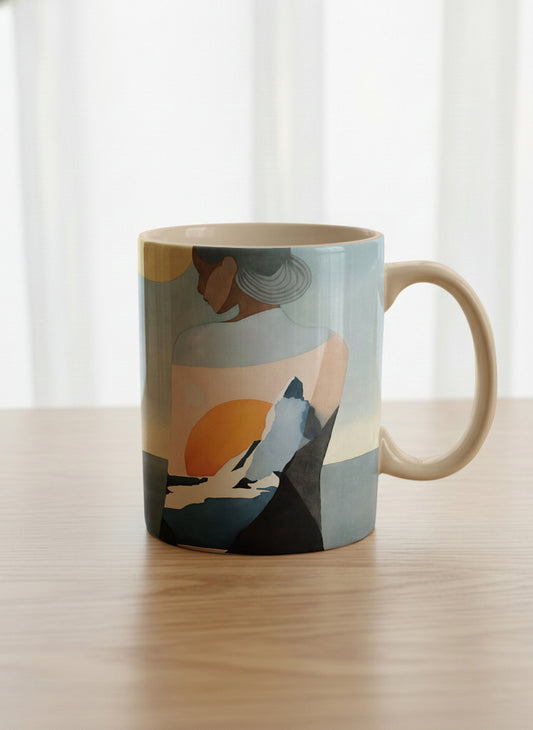 classic mug | A Mountain to Climb mug woman gazing over jagged peaks and a golden sun on teal horizon, butter yellow interior, by KikaG - Gallery By Inhesion