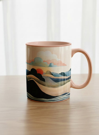Classic mug | Sunset at the River mug rolling hills and dark treetops beneath a soft peach sky with blush and teal clouds and a glowing setting sun, warm peach interior and handle, by KikaG - Gallery By Inhesion