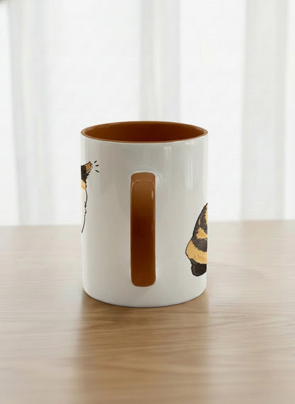 classic Mug | Spicy Calico side view mug grumpy calico cat with piercing green eyes and ruffled fur, dark chocolate interior, by Hyun Jung Cho