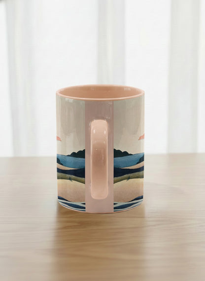 Classic mug | Sunset at the River side view mug rolling hills and dark treetops beneath a soft peach sky with blush and teal clouds and a glowing setting sun, warm peach interior and handle, by KikaG - Gallery By Inhesion
