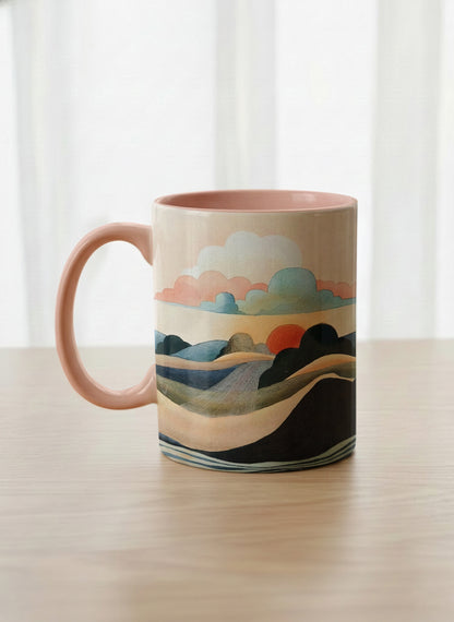 classic mug | Sunset at the River left view mug rolling hills and dark treetops beneath a soft peach sky with blush and teal clouds and a glowing setting sun, warm peach interior and handle, by KikaG - Gallery By Inhesion