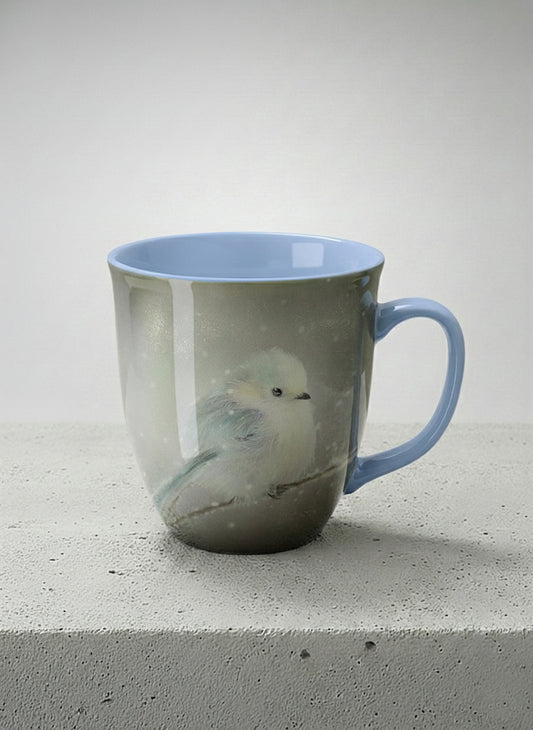 ronny mug | A Moment in the Snow mug, a fluffy white bird perched quietly in a soft wintry haze, sky blue interior and handle, by Karina Mosser - Gallery By Inhesion