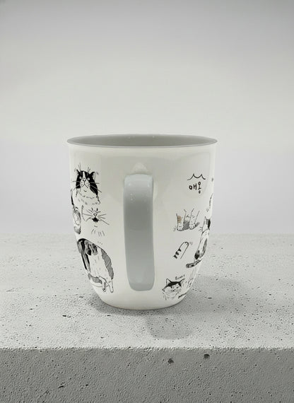 Ronny mug | Moments of Curiosity side view mug  ink-sketched cats in playful poses with Korean script on white, grey interior, by Hyun Jung Cho