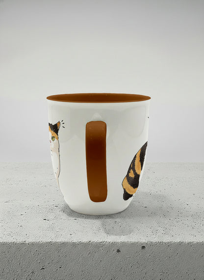 ronny mug | Spicy Calico side view mug grumpy calico cat with piercing green eyes and ruffled fur, dark chocolate interior, by Hyun Jung Cho