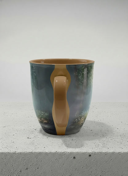 ronny mug | Serenity Stream side view mug, an enchanted forest with glowing light filtering through misty teal trees and wildflowers by a stream, warm olive interior and handle, by Karina Mosser - Gallery By Inhesion