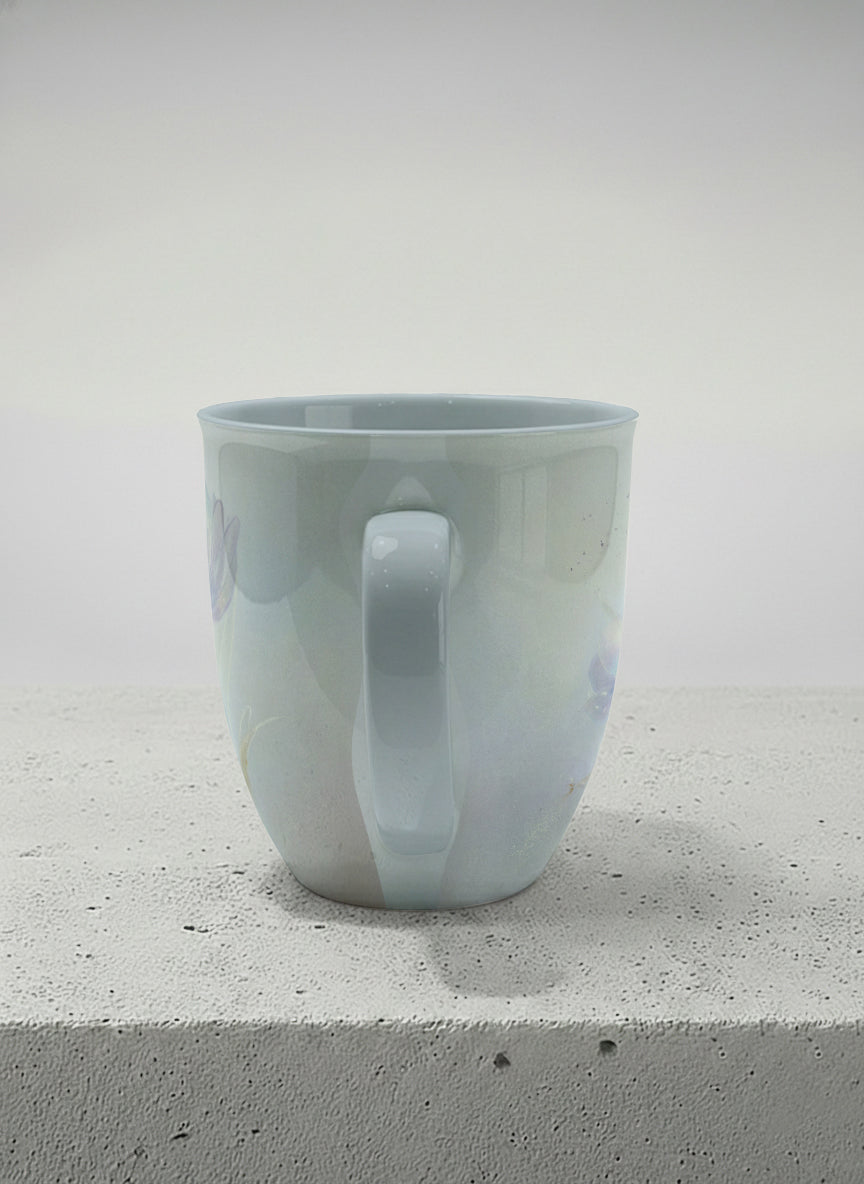 ronny mug | Glass Petals side view mug, a delicate translucent poppy bloom emerging from a soft misty blue-grey wash, matching powder blue interior and handle, by Karina Mosser - Gallery By Inhesion