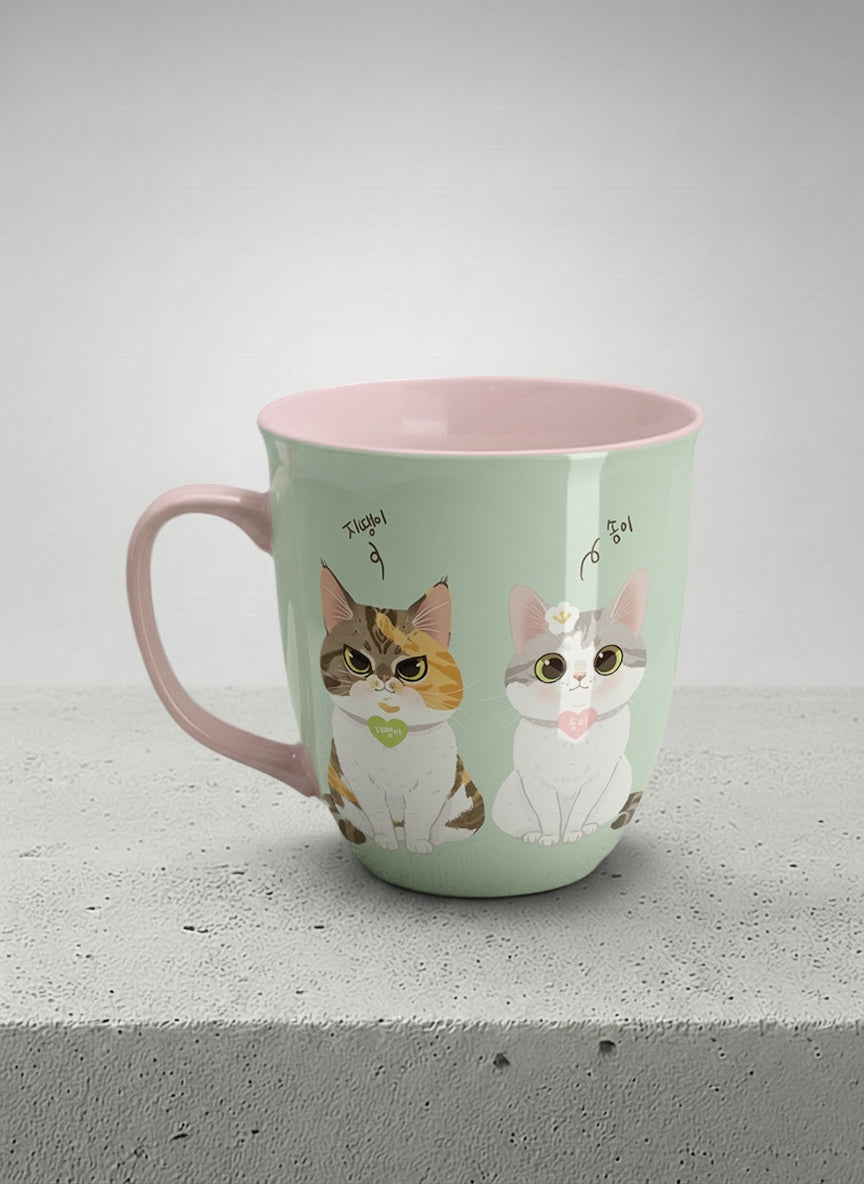 ronny mug | The Perfect Pair left view mug two cats with Korean name tags and bow ties on mint green, blush pink interior, by Hyun Jung Cho