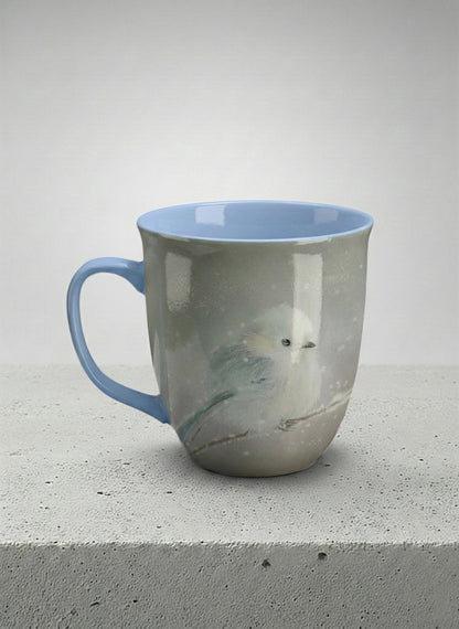 ronny mug | A Moment in the Snow left view mug, a fluffy white bird perched quietly in a soft wintry haze, sky blue interior and handle, by Karina Mosser - Gallery By Inhesion