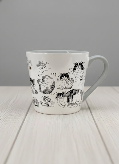 conical mug | Moments of Curiosity mug  ink-sketched cats in playful poses with Korean script on white, grey interior, by Hyun Jung Cho