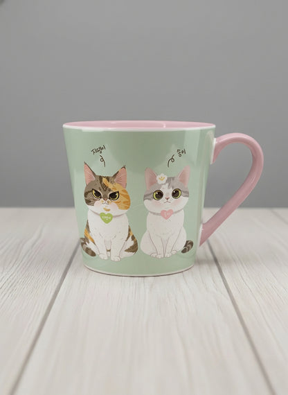 Conical Mug | The Perfect Pair mug two cats with Korean name tags and bow ties on mint green, blush pink interior, by Hyun Jung Cho