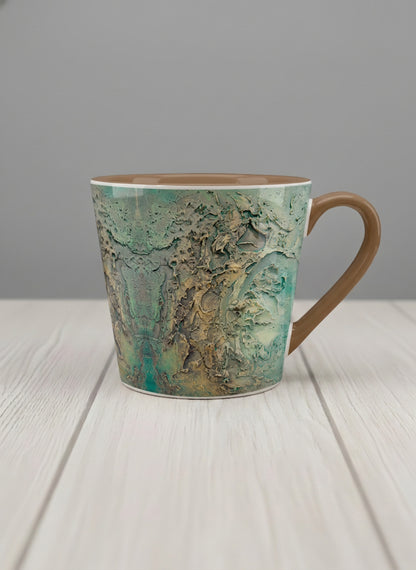 Conical Mug | Green textured mug with earthy, weathered pattern and brown handle on a light surface by Mersedes Mein - Gallery By Inhesion