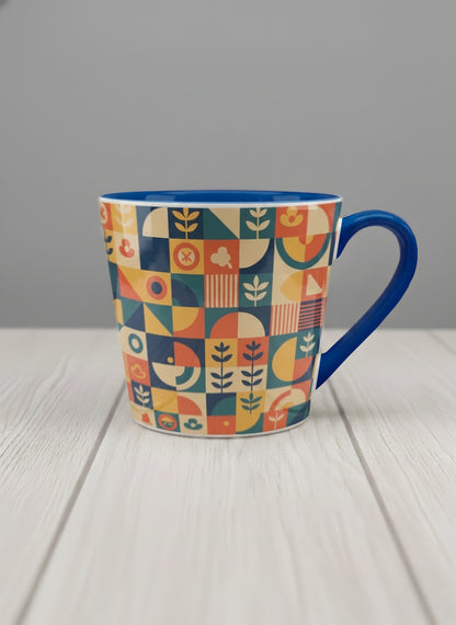 Conical Mug | Bloom Across Realities mug, bold geometric pattern, blue interior and handle, concrete surface  by Alan CL Lee - Gallery By Inhesion