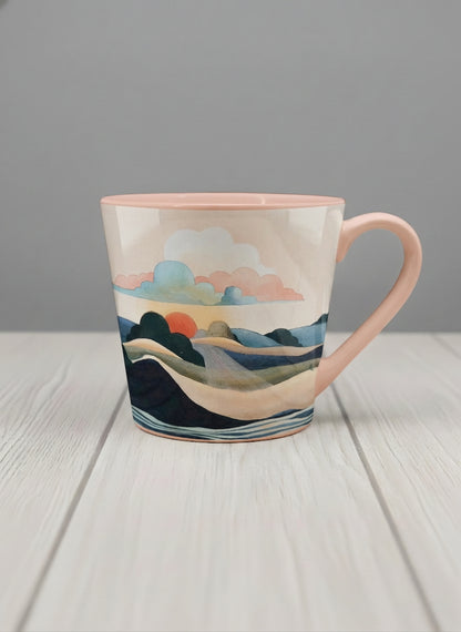 Conical mug | Sunset at the River mug rolling hills and dark treetops beneath a soft peach sky with blush and teal clouds and a glowing setting sun, warm peach interior and handle, by KikaG - Gallery By Inhesion