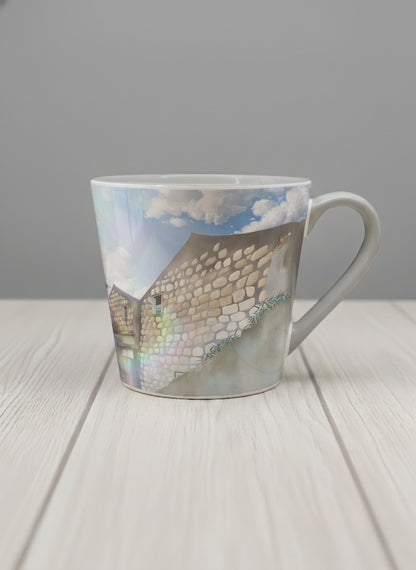 Conical Mug | The Timeless Facade mug ancient stone walls rising under a bright blue sky with soft drifting clouds, clean pearl white interior and handle,  by Samuel Kwok Gallery By Inhesion