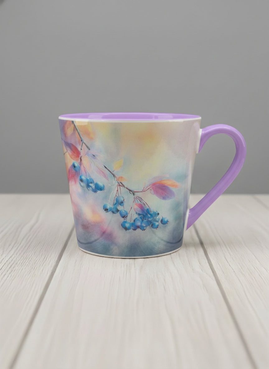 conical mug | Frosted Morning mug, vivid blue berries and autumn leaves drifting across a dreamy pastel rainbow wash, soft lavender interior and handle, by Karina Mosser - Gallery By Inhesion