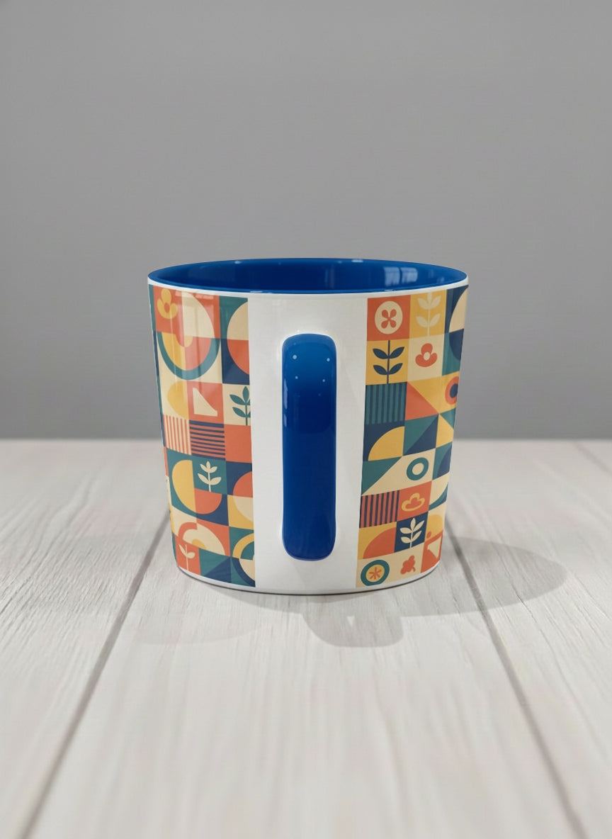 Conical Mug | Bloom Across Realities side view mug, bold geometric pattern, blue interior and handle, concrete surface  by Alan CL Lee - Gallery By Inhesion