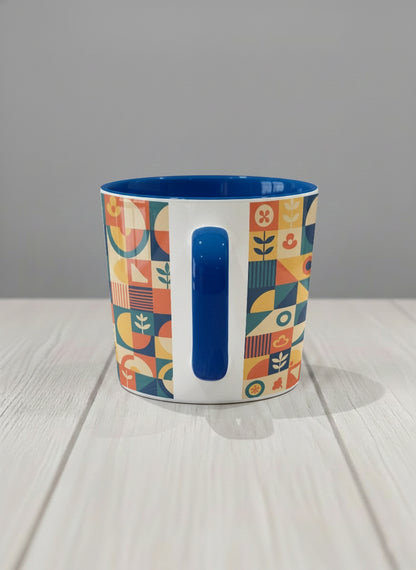 Conical Mug | Bloom Across Realities side view mug, bold geometric pattern, blue interior and handle, concrete surface  by Alan CL Lee - Gallery By Inhesion