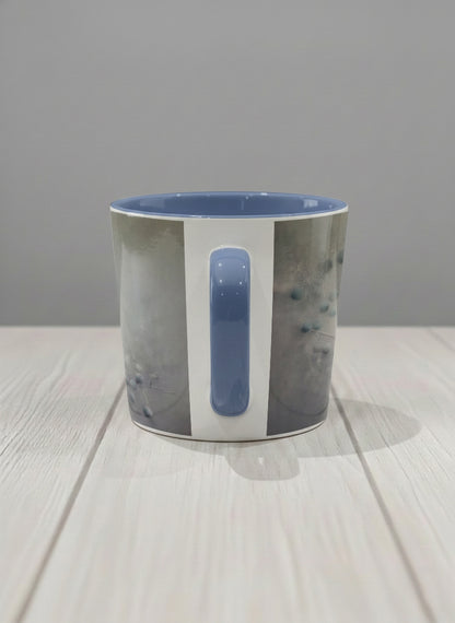 conical mug | A Quiet Moment side view mug, solitary bird perched in a soft misty landscape with delicate dot details, dusty blue interior and handle, by Karina Mosser - Gallery By Inhesion