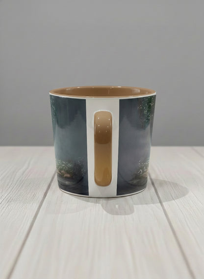 Conical mug | Serenity Stream side view mug, an enchanted forest with glowing light filtering through misty teal trees and wildflowers by a stream, warm olive interior and handle, by Karina Mosser - Gallery By Inhesion
