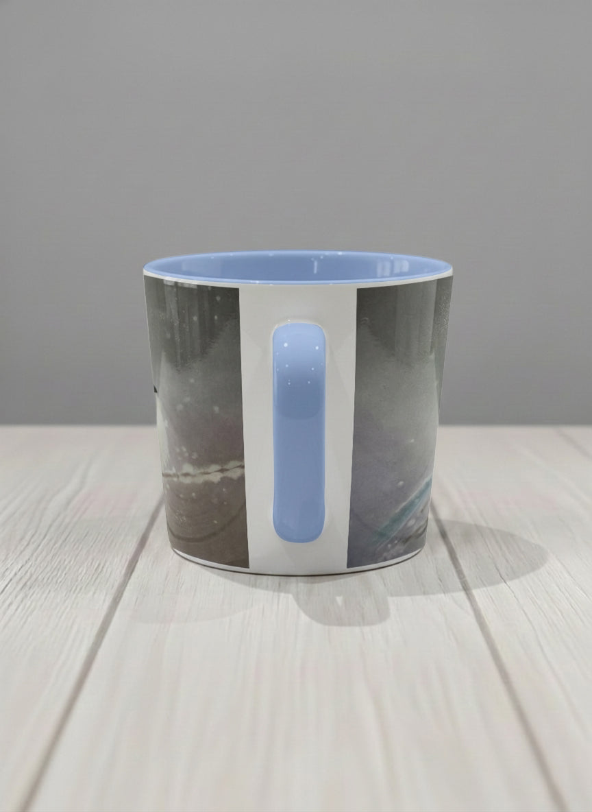 conical mug | A Moment in the Snow side view mug, a fluffy white bird perched quietly in a soft wintry haze, sky blue interior and handle, by Karina Mosser - Gallery By Inhesion