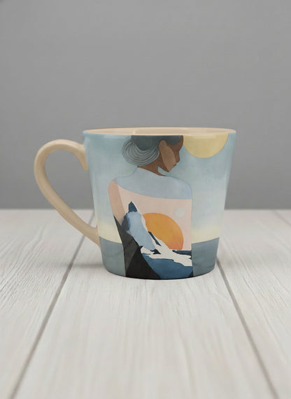 conical mug | A Mountain to Climb left view mug woman gazing over jagged peaks and a golden sun on teal horizon, butter yellow interior, by KikaG - Gallery By Inhesion