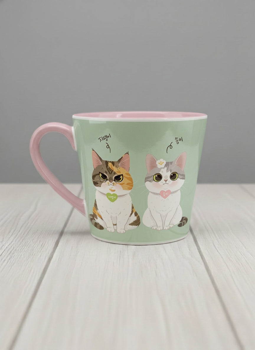 Conical Mug | The Perfect Pair left view mug two cats with Korean name tags and bow ties on mint green, blush pink interior, by Hyun Jung Cho