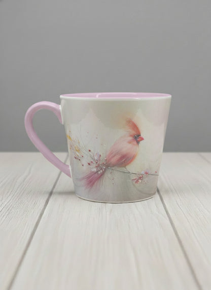 Conical mug | lossom Visitor left view mug, a delicate pink cardinal perched on a wispy blossom branch against a soft ivory mist, blush pink interior and handle, by Karina Mosser - Gallery By Inhesion