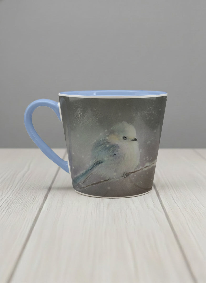 conical mug | A Moment in the Snow left view mug, a fluffy white bird perched quietly in a soft wintry haze, sky blue interior and handle, by Karina Mosser - Gallery By Inhesion