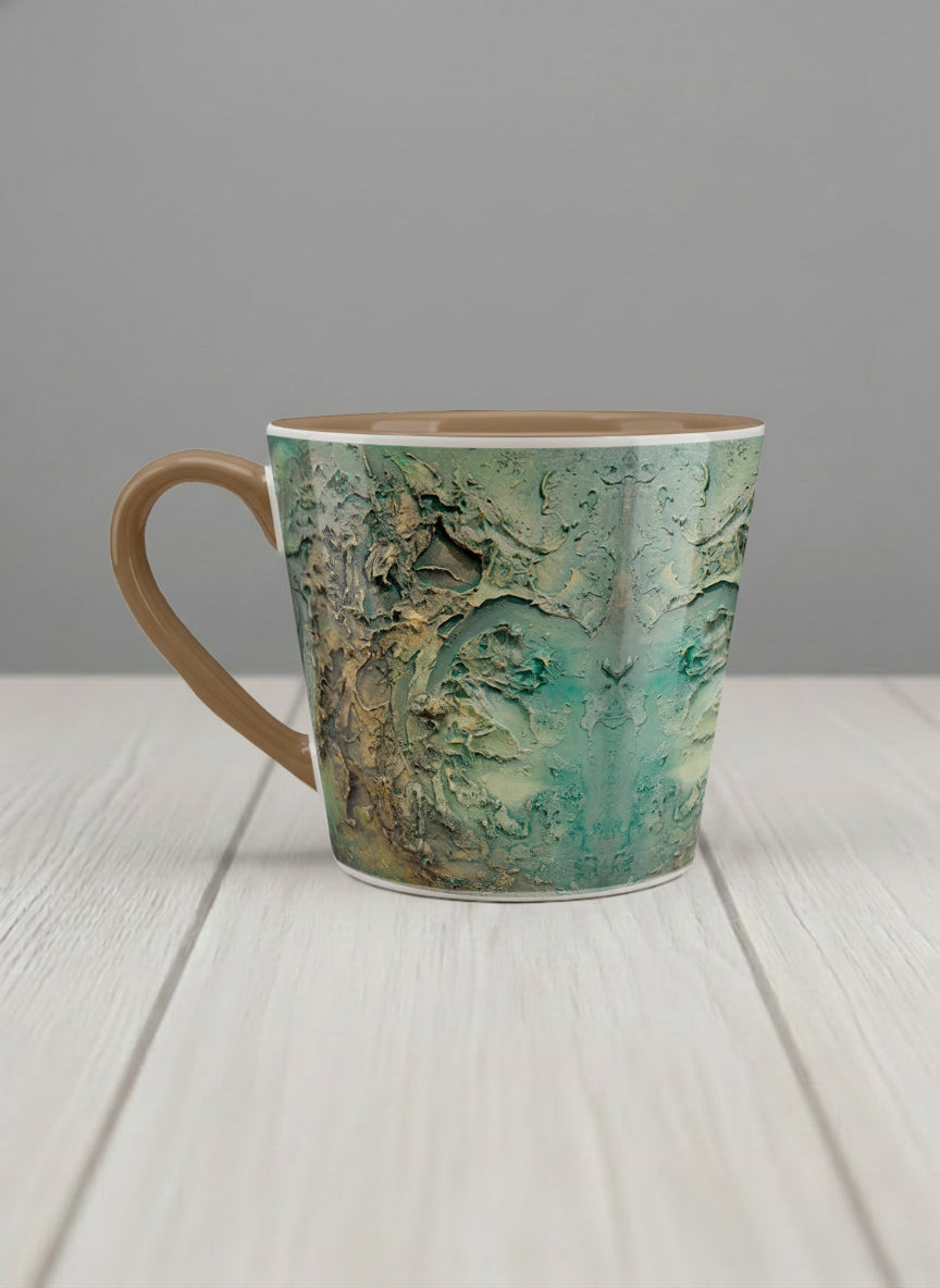 Conical Mug | Green textured left view mug with earthy, weathered pattern and brown handle on a light surface by Mersedes Mein - Gallery By Inhesion